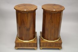 A GOOD PAIR OF BIEDERMEIER COLUMNS with octagonal tops, cupboard doors, on square bases. 83cms