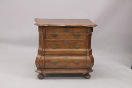 A GOOD 18TH CENTURY DUTCH WALNUT COMMODE, with crossbanded shaped top, three drawers with brass