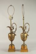A PAIR OF 19TH CENTURY CLASSIC BRONZE JUGS AS LAMPS on square bases. 48cms high.