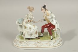 A SITZENDORF PORCELAIN GROUP, a gallant and young lady sitting in chairs. 17cms long x 14cms high.