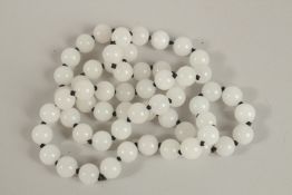 A STRING OF WHITE JADE BEADS. 78cms long.