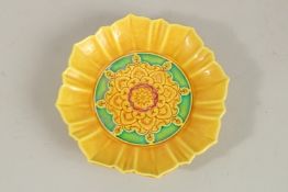 A CHINESE YELLOW GROUND PETAL FORM DISH. 19cms wide.