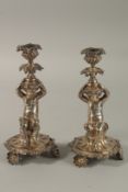 A GOOD PAIR OF 19TH CENTURY PLATE CUPID CANDLESTICKS by WALKER & HALL, SHEFFIELD, the bases with