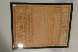 A LARGE 19TH CENTURY FRAMED AND GLAZED SAMPLER with doves, trees and poems. 80cms x 63cms.