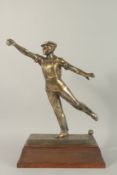 GREGORE, A GOOD PLATED BRASS FIGURE OF A MAN PLAYING BOULES, mounted on a wooden plinth base. 1ft