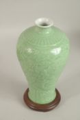A CHINESE CELADON DRAGON MEIPING VASE AND STAND.