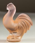 A LALIQUE GLASS ORANGE COCKEREL. 7.5cms high.