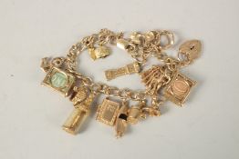A 9CT GOLD CHARM BRACELET with sixteen charms. 55grms.