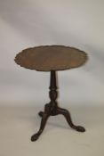 A GEORGE III MAHOGANY TILT TOP TRIPOD TABLE with pie crust top, carved and turned column support, on