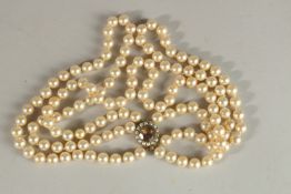 A GOOD THREE ROW PEARL NECKLACE with 9CT GOLD CLASP.