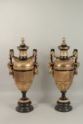 A VERY GOOD PAIR OF BRONZE AND GILT BRONZE TWO-HANDLED URNS with rams mask garlands and pineapple