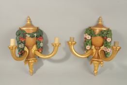 A PAIR OF 20TH CENTURY CARVED, PAINTED AND GILDED TWIN BRANCH WALL APPLIQUES, of urn and floral swag