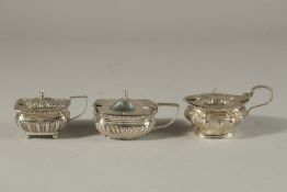 THREE VARIOUS SILVER MUSTARD POTS with gadrooned edge. London 1902, 1926 and 1896. 5ozs.