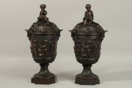 A SUPERB PAIR OF CLASSICAL BRONZE LIDDED VASES, the lids with cupids and acanthus, the body with a