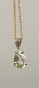 A 9CT YELLOW GOLD PENDANT set with pear shaped green amethyst and a diamond set bale on a gold-