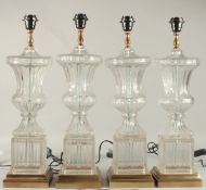 A VERY GOOD SET OF FOUR GLASS URN SHAPED LAMPS on square bases. 60cms high.