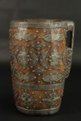 A LARGE, POSSIBLY INDIAN, WOODEN MUG with handle and metal motifs. 32cms high x 19cms diameter.
