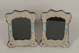 A PAIR OF SILVER AND BLUE ENAMEL PHOTOGRAPH FRAMES decorated with butterflies. 20cms x 16cms.