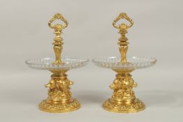 A GOOD PAIR OF LOUIS XVI DESIGN ORMOLU AND GLASS TAZZAS, the bases with four cast hunting dog faces,