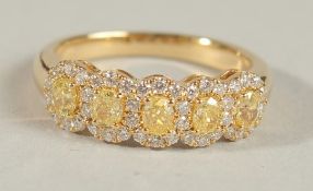 AN 18CT YELLOW GOLD, NATURAL YELLOW DIAMOND AND WHITE DIAMOND FIVE-STONE CLUSTER RING.