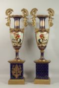 A VERY GOOD PAIR OF TALL FRENCH TWO-HANDLED BLUE VASES ON STAND with figural handles, with gilt