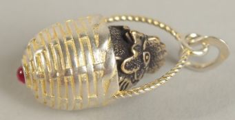 A SILVER CHICK IN A BASKET PENDANT.
