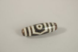 A GOLD INLAID DZI BEAD.
