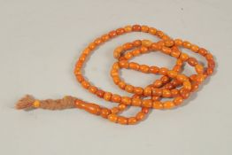 A STRING OF ONE-HUNDRED AMBER BEADS. Weight 38gms.