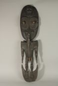 A LARGE SEPIK CARVED WOOD STANDING FIGURE OF A MAN with large oval head. 93cms high.