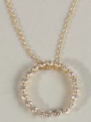 AN 18CT YELLOW GOLD DIAMOND CIRCULAR PENDANT on a chain.