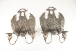 A PAIR OF BRONZE BAT WING WALL SCONCES with double scrolling branches. 33cms long.