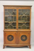A LATE 19TH CENTURY SATINWOOD CUPBOARD BOOKCASE, with a Greek key and leaf painted cornice, the pair