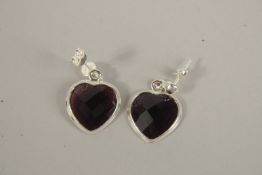 A PAIR OF AMETHYST SILVER HEART SHAPED EARRINGS.