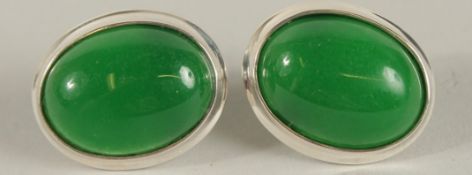 A PAIR OF SILVER AND JADE OVAL EARRINGS.