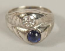 A 14CT WHITE GOLD, DIAMOND AND SAPPHIRE TWO-STONE RING. Ring Size IJ.