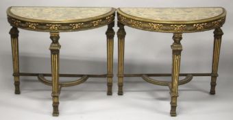 A GOOD PAIR OF 19TH/20TH CENTURY PAINTED AND PARCEL GILDED DEMILUNE CONSOLE TABLES, with