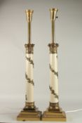A GOOD PAIR OF PORCELAIN AND GILT METAL COLUMN LAMPS with vine leaves, on square bases. 60cms high.