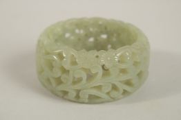 A GOOD PIERCED CELADON BANGLE. 7cms diameter.