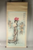 A LARGE JAPANESE SCROLL PAINTING ON PAPER, depicting a female figure, with calligraphy to upper