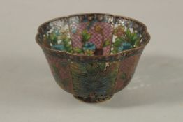 A CHINESE PEKING GLASS WIREWORK BOWL, decorated with floral openwork panels, 10.5cm wide.