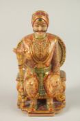 AN INDIAN CARVED AND PAINTED MARBLE ENTHRONED MAHARAJA FIGURE, painted with fine floral details