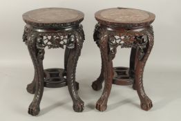 A PAIR OF 19TH CENTURY CHINESE MARBLE INSET HARDWOOD STANDS, with carved and pierced frieze on