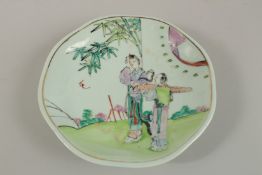 A CHINESE FAMILLE VERTE PORCELAIN DISH, painted with figures in a garden, 21cm wide.