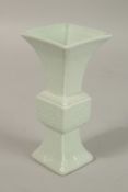 A CHINESE CELADON MINIATURE PORCELAIN GU VASE, with six-character mark, 12.2cm high.