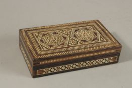 A MICRO-MOSAIC BONE INLAID WOODEN BOX, with geometric designs and hinged lid, 17cm x 10cm.