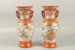 A PAIR OF JAPANESE KUTANI PORCELAIN TWIN HANDLE VASES, painted with panels of figures and flora,