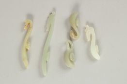 A COLLECTION OF FOUR QING DYNASTY BELT HOOKS, (4).