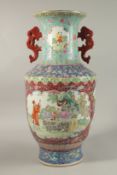 A LARGE CHINESE FAMILLE ROSE PORCELAIN TWIN HANDLE VASE, on a ground of turquoise, blue, and red,