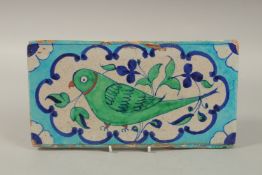 A FINE EARLY 19TH CENTURY NORTH INDIAN MULTAN GLAZED POTTERY TILE, with central parrot design,
