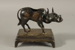 AN INDIAN KERALA BRONZE FIGURE OF A BULL, mounted to a rectangular base elevated on four feet,